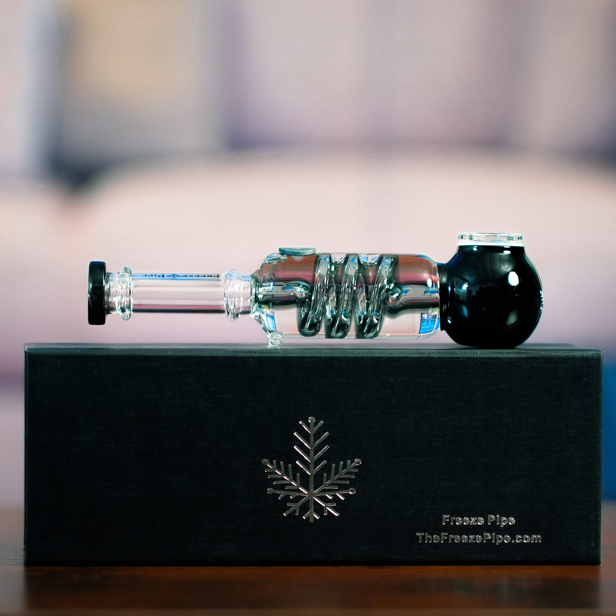 Freeze Pipe displayed on black case with detachable glycerin coil and glass mouthpiece