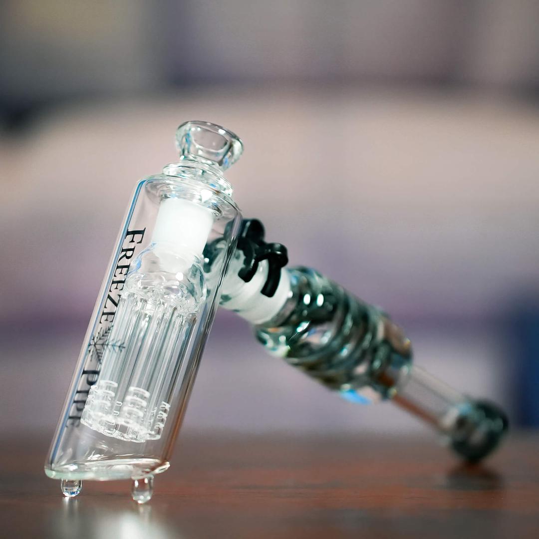 Person using Freeze Pipe Bubbler — Ice-Cooled Glass Pipe for Smooth Draws