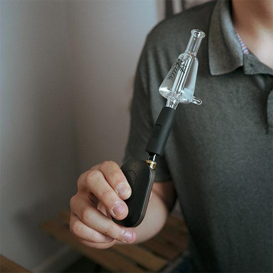 Man using Freeze Pipe Joint Chiller — portable glycerin-coil glass attachment for smooth, cool hits