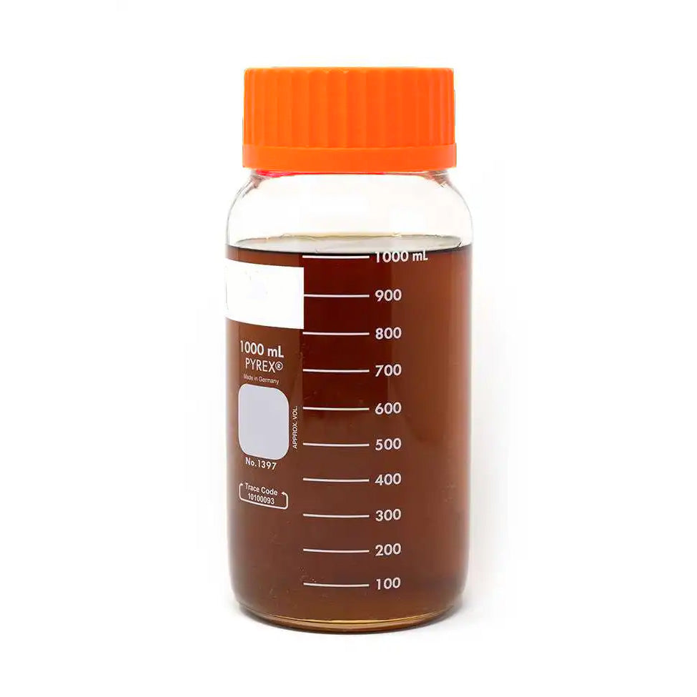 1000 mL Pyrex container with dark golden full spectrum distillate oil, displaying measurement markings.