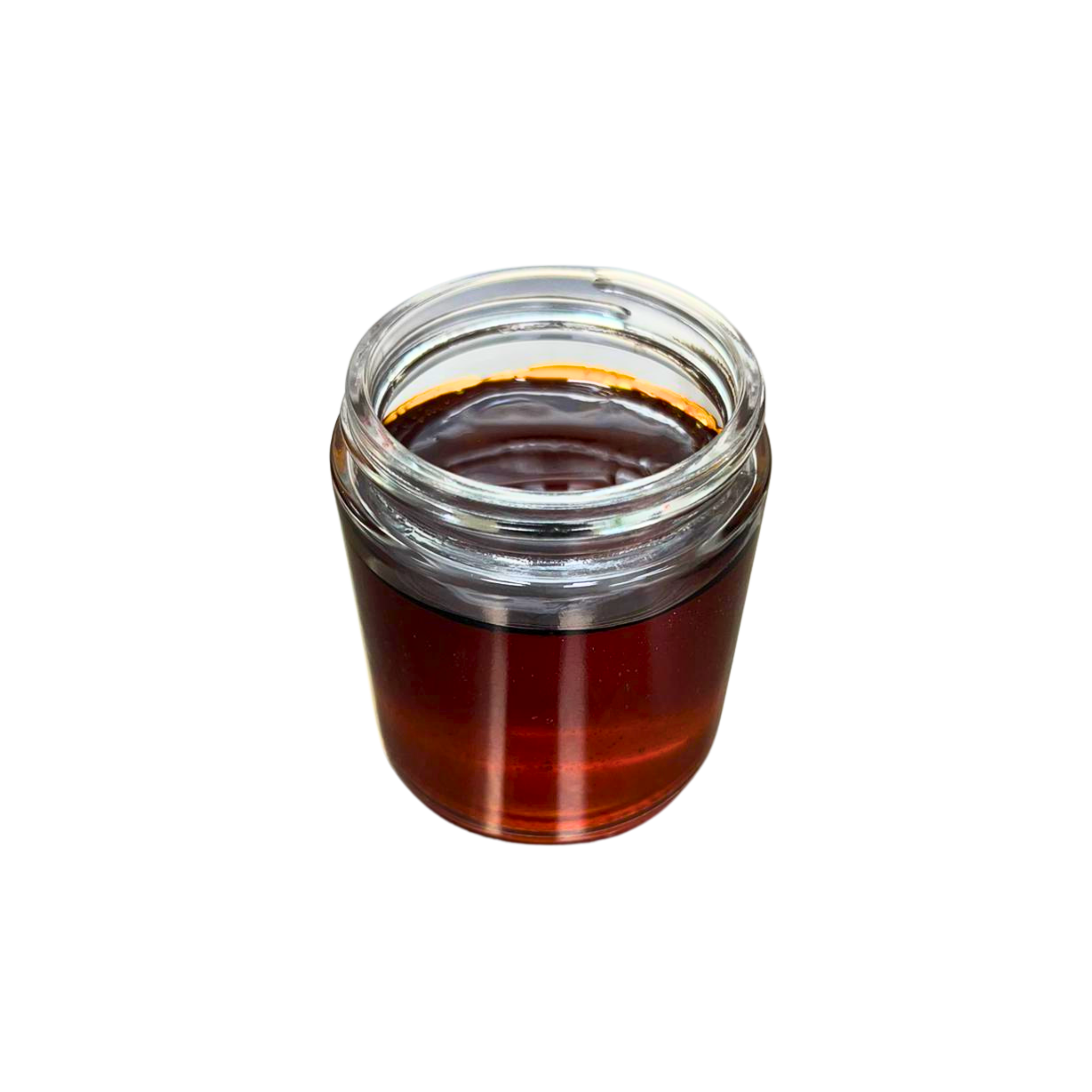 Top-down view of THCv distillate jar showing deep amber clarity and viscosity.